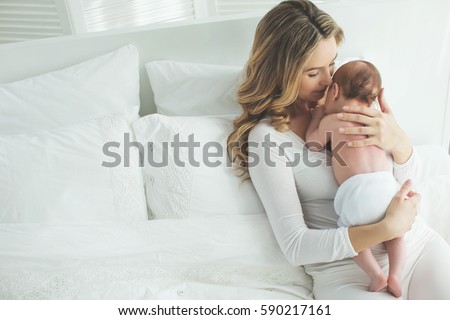 Similar – Image, Stock Photo Mother breastfeeding and hugging her baby boy outdoors