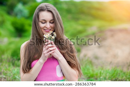 Beautiful Young Woman Outdoors. Enjoy Nature. Daisies