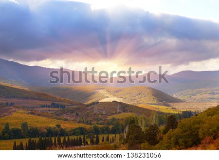 Mountain landscape with sun and clouds