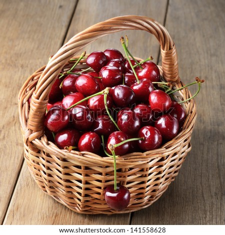 Basket of organic Cherries on wooden table