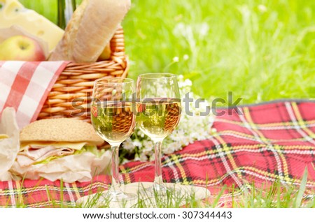 Picnic basket with apples bread cheese wine and sandwiches