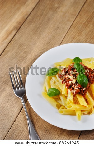 Rigatoni pasta with a tomato bolognese beef sauce on the kitchen table