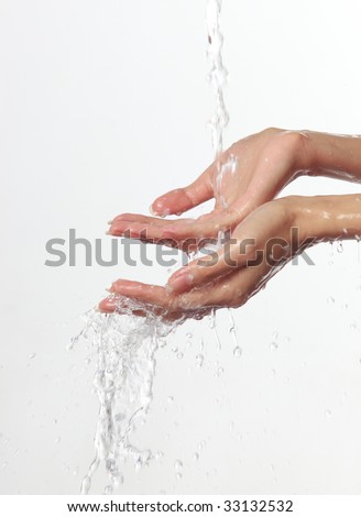 Women\'s hands and stream of water On white background.
