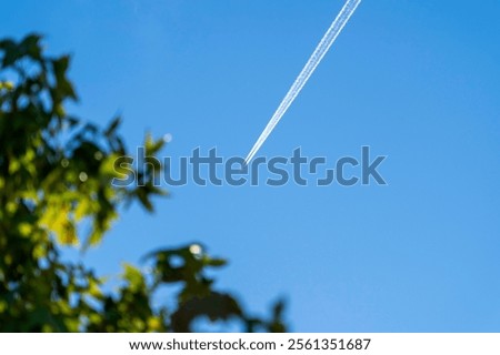 Similar – Foto Bild Ein Kondensstreifen am blauen Himmel und Äste eines blühenden Kirschbaumes lassen von der nächsten Urlaubsreise träumen / Frühling / Urlaubsplanung