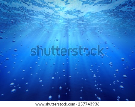 Blue ocean underwater light rays shining and gas bubbles.