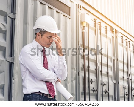 Exhausted/tired/sad/disappointed/frustrated young asian engineer/architect/businessman working at factory job site  Stock photo © 