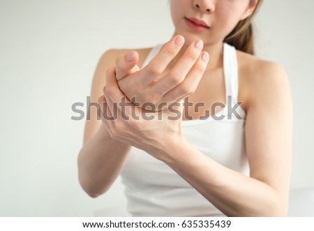 Asian woman pain at wrist, arm and hand, feel ache, Inflammation, woman muscle pain concept 商業照片 © 