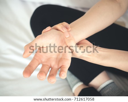 Asian woman pain at wrist, arm and hand, feel ache, Inflammation, woman muscle pain concept 商業照片 © 