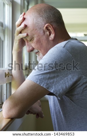 Older man expressing pain or depression.