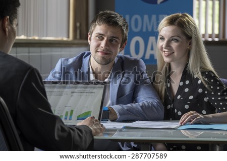 A young couple meeting with a banker for a home loan