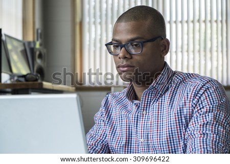Young black male working on a computer in an office setting