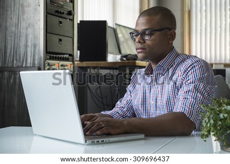 Young black male working on a computer in an office