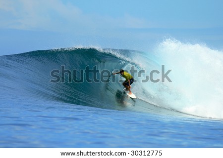 Surfer in yellow t-shirt in barrel, Mentawai Islands, Indonesia
