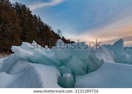 Similar – Image, Stock Photo Shoving snow on the roof. Remove snow from solar system