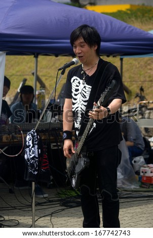 OSAKA, JAPAN - JUNE 19: Free Gizzy concert at Osaka Castle Park on June 19, 2013, Osaka, Japan. Open parks in Japan are favorite places for young bands to show their talents to the audience.