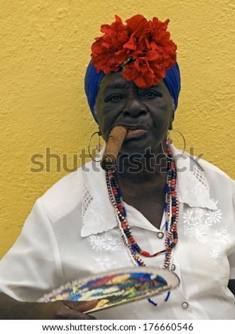 HAVANA, CUBA - JANUARY 30 : Cuban lady with cigar on 30 January, 2014, Havana, Cuba. Cigar is famous in Cuba, almost everybody smokes it including women.