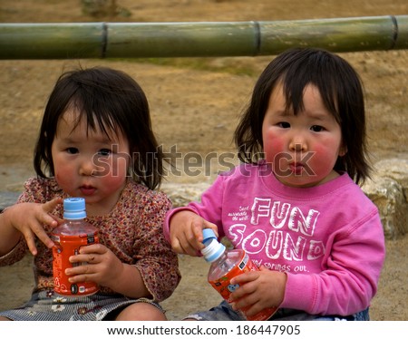 KYOTO, JAPAN - MARCH 29: Cute Japanese twins at March 29, 2014 in Kyoto, Japan. Japanese families have less and less children, so the population is declining.