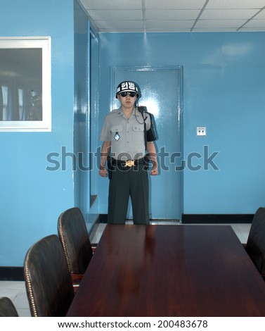PANMUNJOM, SOUTH KOREA - MAY 17: Korean soldier in the MAC Building on May 17, 2014 in Panmunjom, South Korea. The armistice agreement was signed in 1953 which divided Korea in two parts.