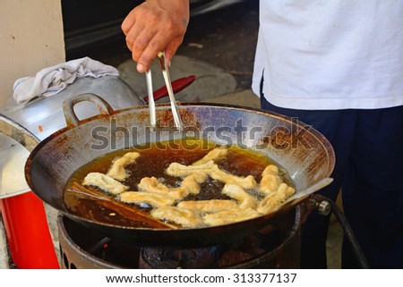 MALAYSIA - MARCH 1 : Fried fish under prepare in a Dayak village on 9 March 2015 in Malaysia, Borneo. Dayaks are the native tribes of Borneo.