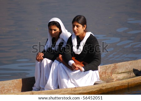 SRINAGAR, INDIA - OCTOBER 12: Muslim girls go to school by boat on Dal Lake, October 12, 2009 in Srinagar, Kashmir, India