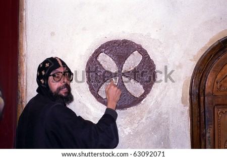 WADI NATRUN, EGYPT - NOVEMBER 28 : Coptic monk teaches religious symbols at 28 November, 1998 in Wadi Natrun, Egypt. Coptic is an ancient Christian religion remained in Egypt during centuries.