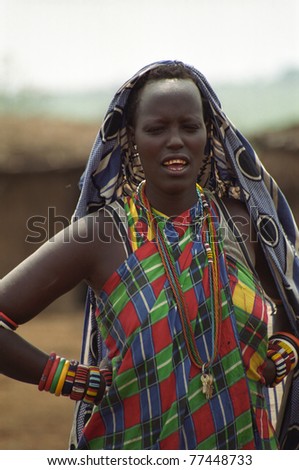 MAASAI MARA, KENYA - FEBRUARY 4: Maasai woman in the village, 4 February , 2004 at Masaai Mara, Kenya. The Maasai are the most famous tribe in Africa. They are nomadic and live in small villages.