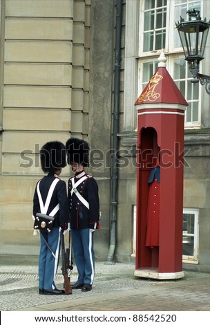 COPENHAGEN, DENMARK - MAY 19 : Royal guards at Amalienborg Slot at May 19, 2001 in Copenhagen, Denmark. This palace is the home of the Danish royal family and a top tourist attraction as well.