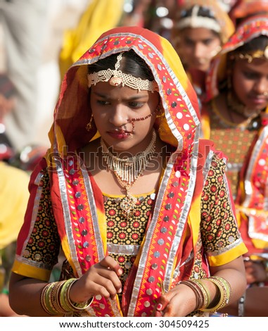 PUSHKAR, INDIA - NOVEMBER 21: An unidentified girls in colorful ethnic attire attends at the Pushkar fair on November 21, 2012 in Pushkar, Rajasthan, India.
