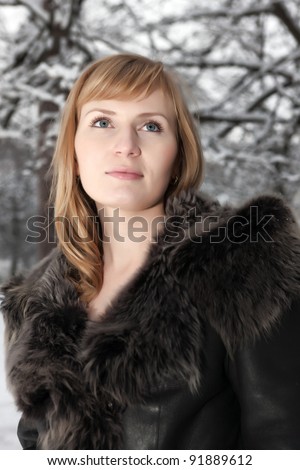 Beautiful young woman in winter fur coat. Winter portrait