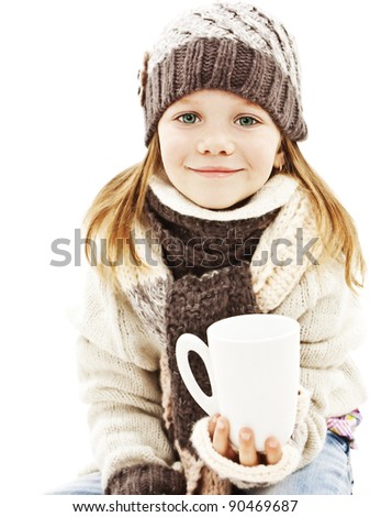 Smiling little girl with a white cup of hot drink. Isolated on white background