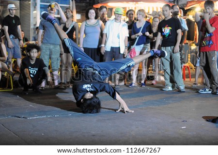BANGKOK - JAN 3: An unidentified b-boy breakdances at an informal street dance meet on Jan 3, 2011 in Bangkok, Thailand. Breakdancing is a popular activity of youth in the Thai capital.