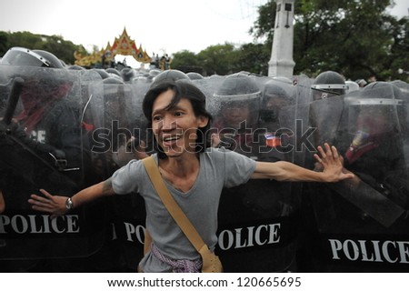 BANGKOK - NOV 24: A  protester from the nationalist Pitak Siam confronts riot police during a violent anti-government rally on Nov 24, 2012 in Bangkok, Thailand.