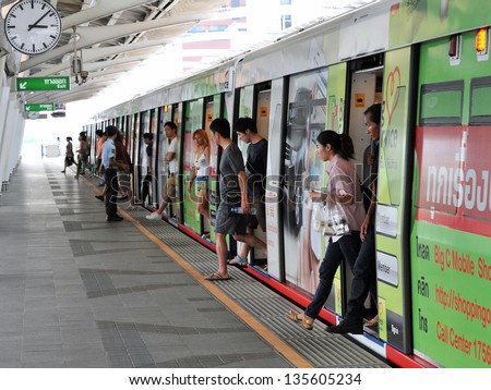 BANGKOK - APR 12: Passengers alight a BTS Skytrain at a station in the city centre on Apr 12, 2013 in Bangkok, Thailand. Each train of the mass transport rail network can carry over 1,000 passengers.