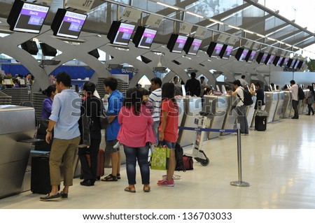 BANGKOK - SEPT19: Passengers arrive at check-in counters at Suvarnabhumi Airport on Sept 19, 2012 in Bangkok, Thailand. The airport is one of the busiest in Asia, handling 45mn travellers annually.
