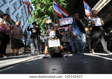 BANGKOK - JUN 9: A disabled protester wearing a Guy Fawkes mask leads an anti-government rally through Bangkok\'s shopping district on Jun 9, 2013 in Bangkok, Thailand.