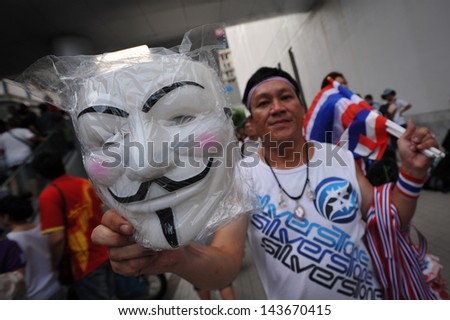 BANGKOK - JUNE 16: An unidentified man sells Guy Fawkes masks at a large anti-government rally in Bangkok\'s shopping district on June 16, 2013 in Bangkok, Thailand.