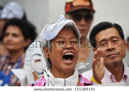 BANGKOK - JUN 30: An unidentified protester shouts anti-government slogans at a political rally on Jun 30, 2013 in Bangkok, Thailand. The protesters call for the government to be overthrown.