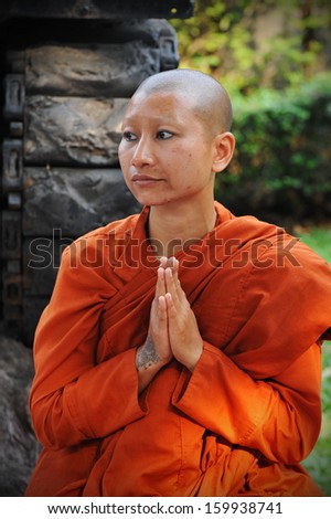 BANGKOK - JAN 25: A Buddhist monk prays while attending a pilgrimage through the Thai capital on Jan 25, 2013 in Bangkok, Thailand. 1,128 monks have joined the pilgrimage of over 26 days and 446 km.