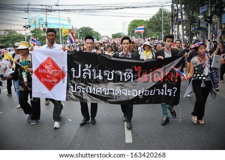 BANGKOK - NOV 11: Unidentified protesters march through the Thai capital to join a large anti-government rally on Nov 11, 2013 in Bangkok, Thailand.