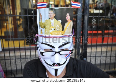 BANGKOK - JUNE 30: A protester wearing hat depicting the Thai King joins an anti-government rally in the city centre on June 30, 2013 in Bangkok, Thailand. Protesters rallied against the government.