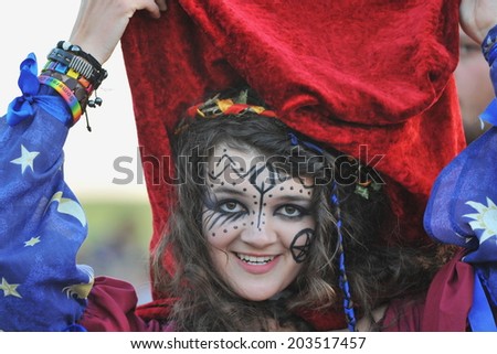 STONEHENGE - JUNE 20: An unidentified reveller joins celebrations to mark the Summer Solstice on June 20, 2014 in Stonehenge, UK. Thousands gathered at the historic monument to celebrate the solstice.