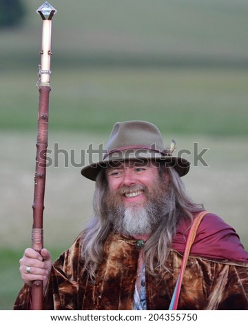 STONEHENGE - JUNE 20: An unidentified druid joins celebrations to mark the Summer Solstice on June 20, 2014 in Stonehenge, UK. Thousands gathered at the historic monument to celebrate the solstice.