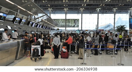 BANGKOK - SEP 19: Travellers queue at check-in counters at Suvarnabhumi Airport on Sep 19, 2012 in Bangkok, Thailand. The Thai capital\'s main international terminal handles 45 mln travellers annually.
