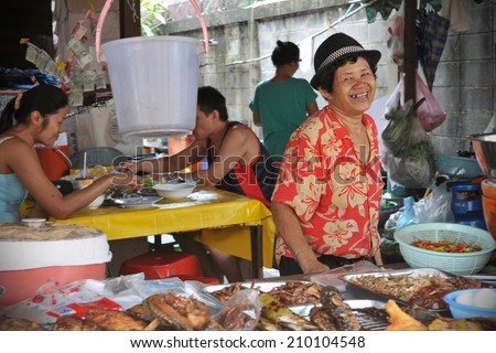 BANGKOK - SEP 22: Unidentified vendors prepare food at a streetside restaurant on Nov 1, 2011 in Bangkok, Thailand. Government statistics indicate 16,000 registered street vendors in the Thai capital.