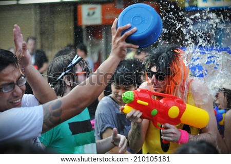 BANGKOK - APRIL 13: Unidentified revellers take part in a water fight event on Khao San Road during celebrations of Songkran, or the Thai New Year, on April 13, 2012 in Bangkok, Thailand.