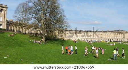 BATH - APR 4: Unidentified people gather in Victoria Park below the landmark Royal Crescent on Apr 4, 2011 in Bath, UK. Bath is a UNESCO World Heritage city with over 3.8 million visitors per year.