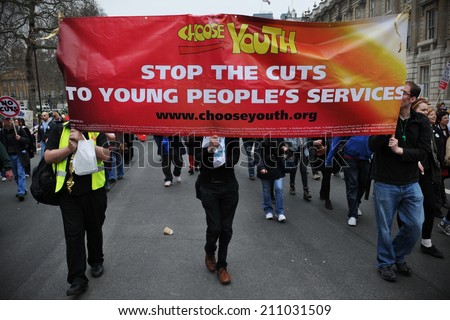 LONDON - MAR 26: Protesters march through the British capital in opposition to government spending cuts on Mar 26, 2011 in London, UK. An estimated 250,000 people took part in the TUC organised rally.