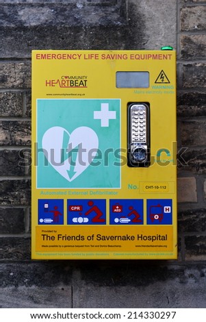 MALBOROUGH - AUG 31: View of a cabinet containing emergency life saving medical equipment on a wall in the town centre on Aug 31, 2014 in Malborough, UK. The cabinet was funded with local donations.