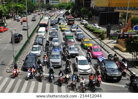 BANGKOK - JUN 1: Traffic waits at a busy junction in the city centre on Jun 1, 2014 in Bangkok, Thailand. Annually an estimated 150,000 new cars join the heavily congested roads of Bangkok.