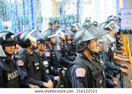 BANGKOK - JAN 9: Riot police block an entrance to Sukumvit Road during a 30,000 strong anti government Red Shirt protest in the city centre of the Thai capital on Jan 9, 2011 in Bangkok, Thailand.